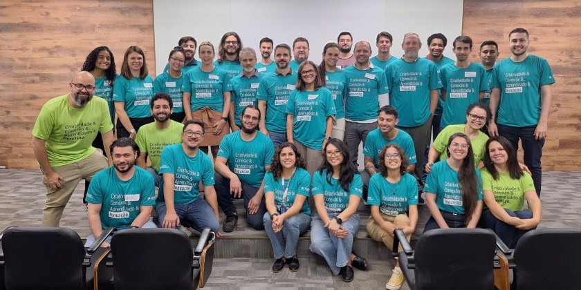 Participantes do evento de reinauguração do prédio da Incamp vestidos com camisas na cor verde Fim da descrição.